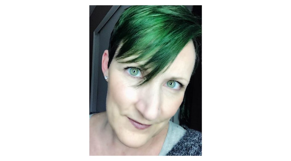 Laura Watson close up portrait with green hair for st Patricks day
