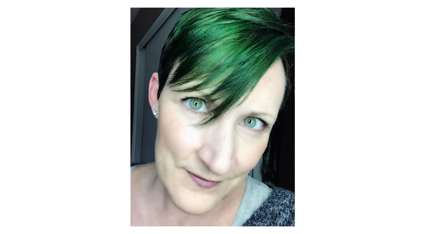 Laura Watson close up portrait with green hair for st Patricks day