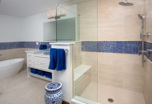 Master bathroom remodel with blue tile and vase