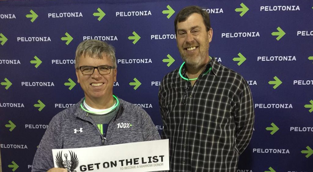 2015 Pelatonia Celebration George Cleary in front of pelotonia logo backdrop