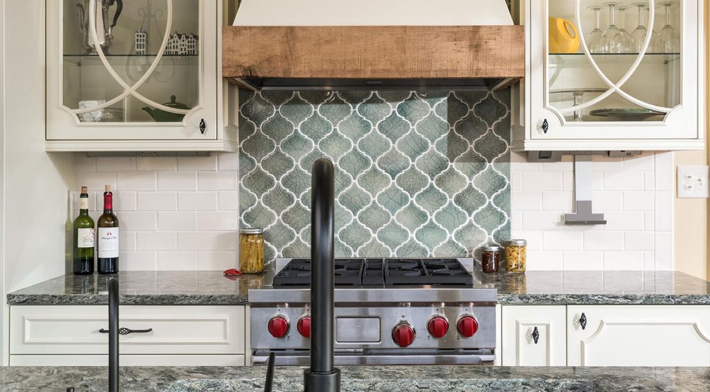 Kitchen remodeled by Cleary view of gas stove with blue tile backsplash